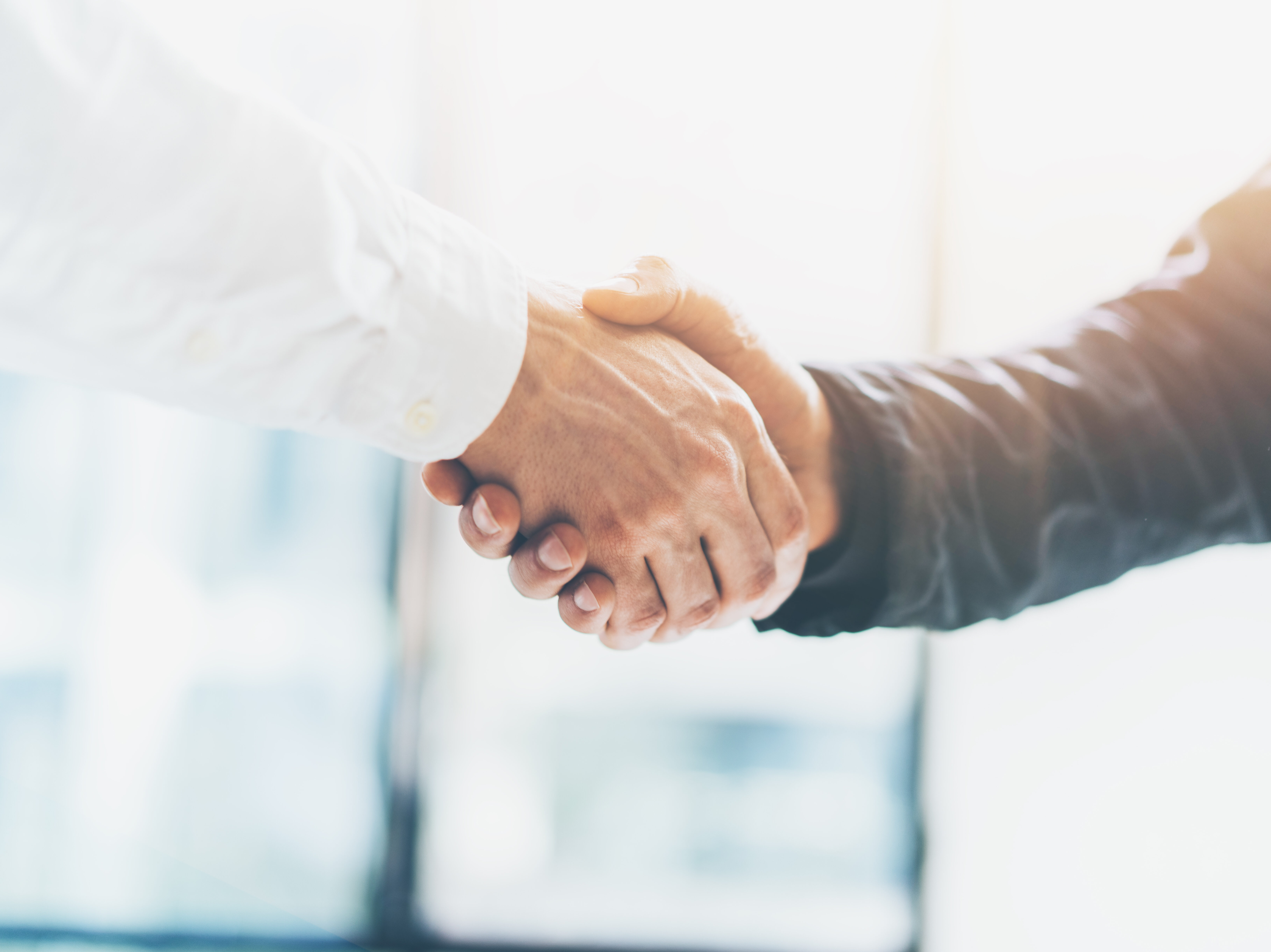Business partnership meeting. Picture businessmans handshake. Successful businessmen handshaking after good deal. Horizontal, blurred background